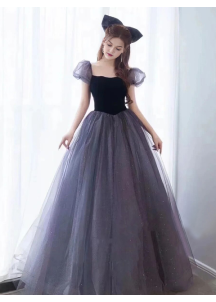 Evening gown in glittering gray tulle and black velvet with puff sleeves