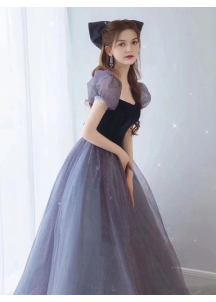 Evening gown in glittering gray tulle and black velvet with puff sleeves