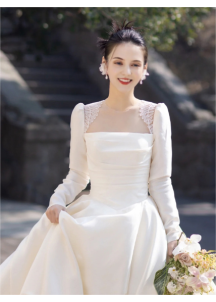 Classic white satin wedding gown with long sleeves