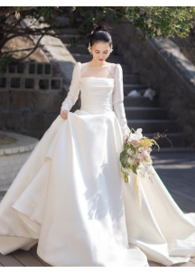 Classic white satin wedding gown with long sleeves