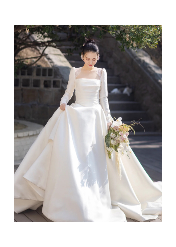 Classic white satin wedding gown with long sleeves