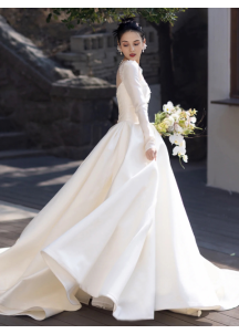 Classic white satin wedding gown with long sleeves