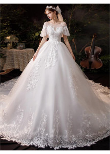 Wedding dress with short puffy sleeves and a long train