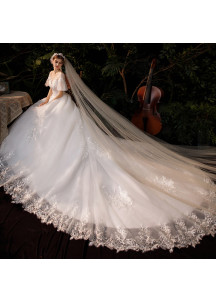 Wedding dress with short puffy sleeves and a long train